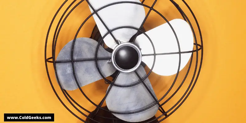 A metal fan against a yellow background—Can fans hurt you