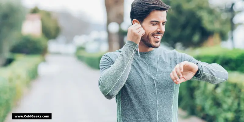 Man with earbuds being active—What Is a Neck Fan?